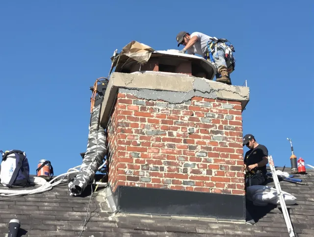 Westport Chimney Sweep installing a custom chimney crown in Westport, MA